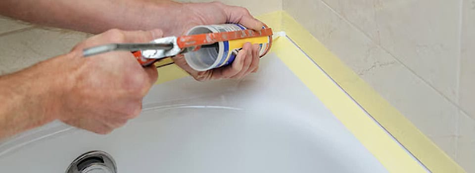 Caulk all seams with 100% silicone where the tub meets the wall and floor