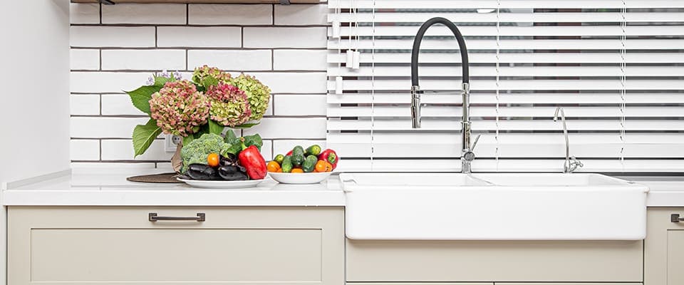 Kitchen interior near the wash basin with white cabinets in a minimal style.