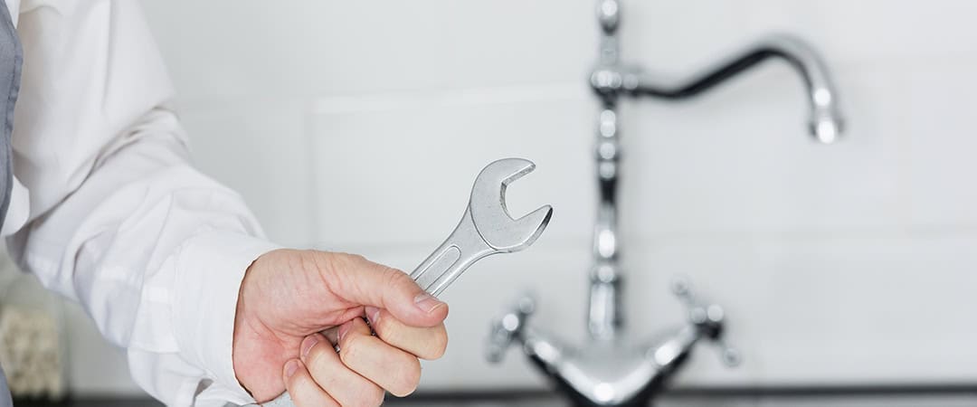 The plumber is preparing to replace the faucet The Invisible Impact of Local Water on Faucet Lifespan