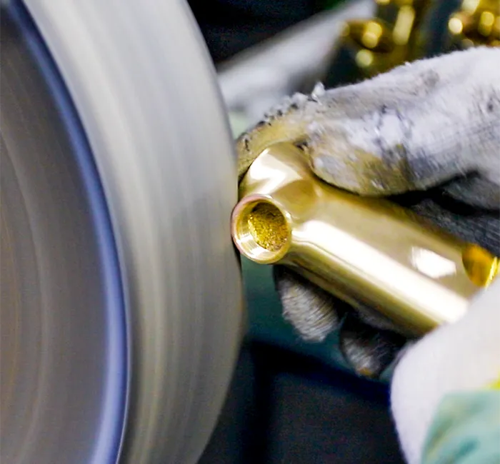 Worker polishing a brass faucet body at the Luxuryhome factory in Jiangmen