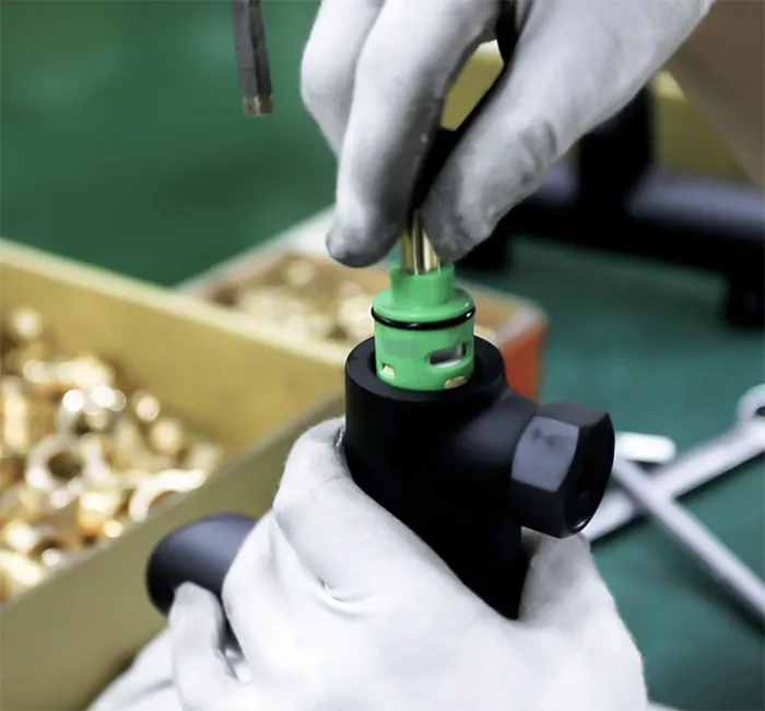 Worker assembling a shower valve at the Luxuryhome factory in Jiangmen