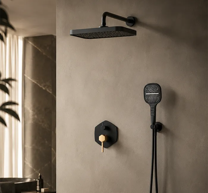 Matte black concealed shower system with rainfall showerhead, handheld shower and rose gold control in a luxury bathroom.